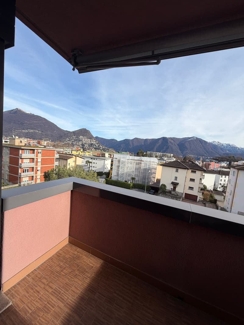 Balcony with tiled floor, view of mountains and city