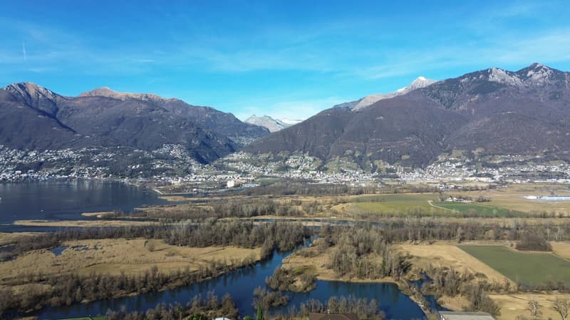 mountain range, a lake, and a town in the distance