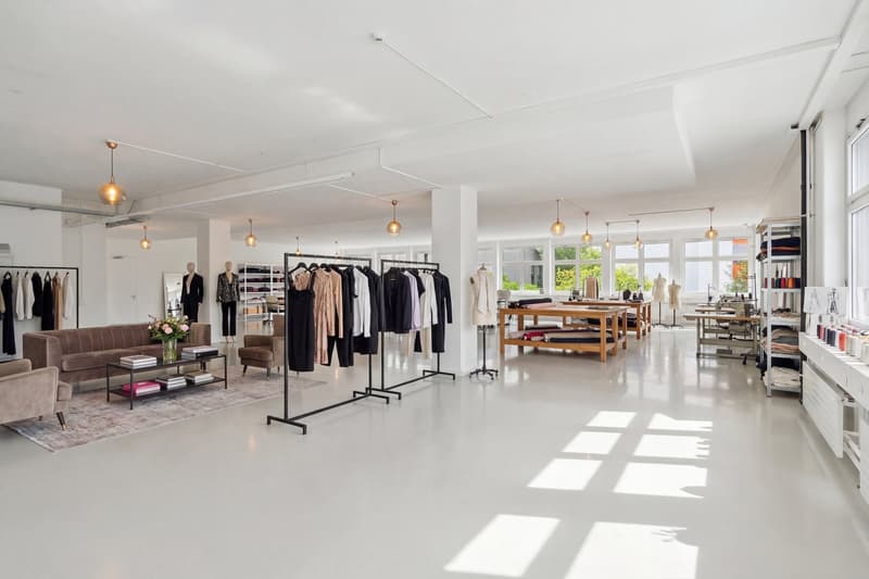 white walls, white floor, clothing racks, tables, chairs, shelves, lamps