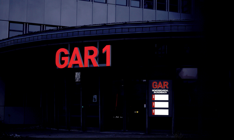 Large commercial building with prominent red 'GAR1' signage and a garage entrance.