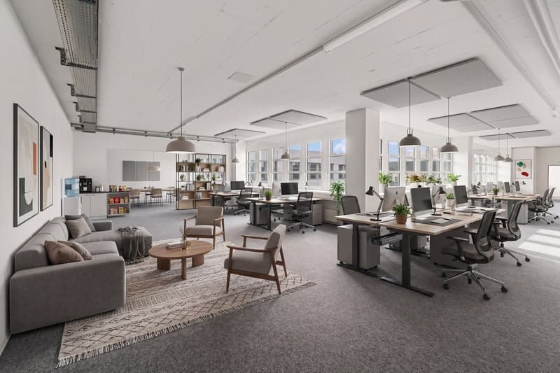 modern office space with desks, chairs, plants, and a couch