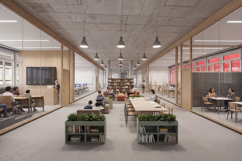 Open space with tables, chairs, bookshelves, and a library area with bookshelves and reading couches.
