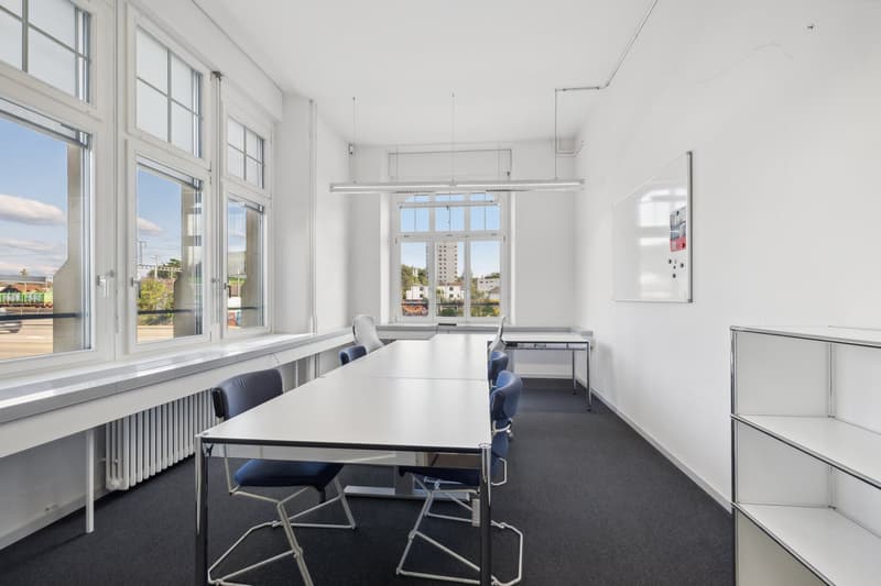 meeting room, long white table, blue chairs, radiator, glass windows, large room, white board on wall