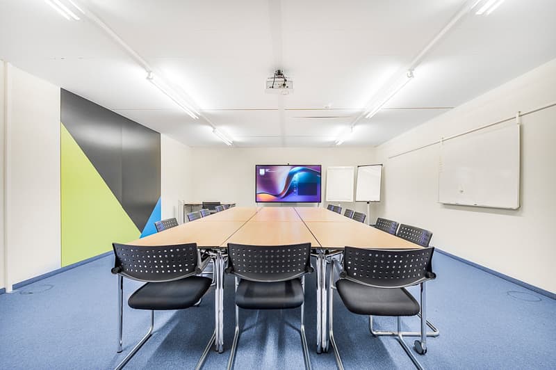 empty meeting room with long table, chairs, projector, whiteboards
