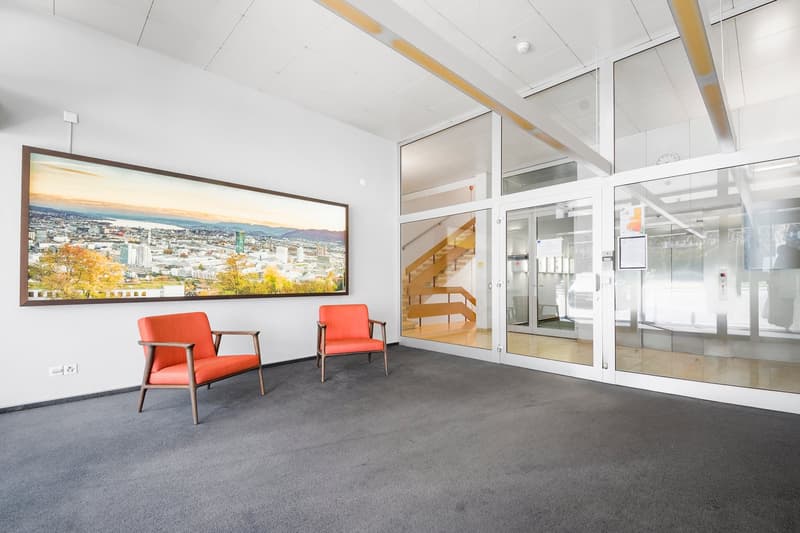 empty room, two orange chairs, large picture frame, glass doors, carpeted floor