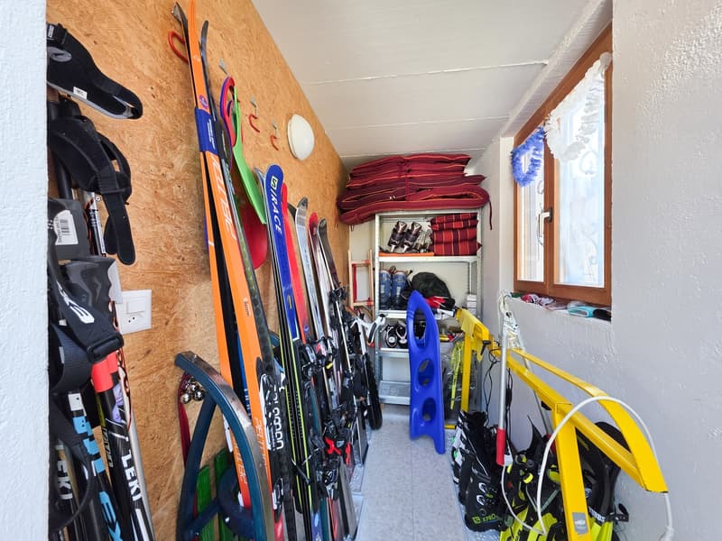Storage room with skis, snowboards, and winter sports equipment