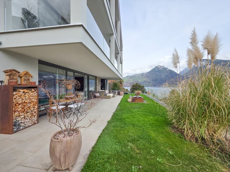 modern house, glass walls, balcony, outdoor seating, garden, lake view