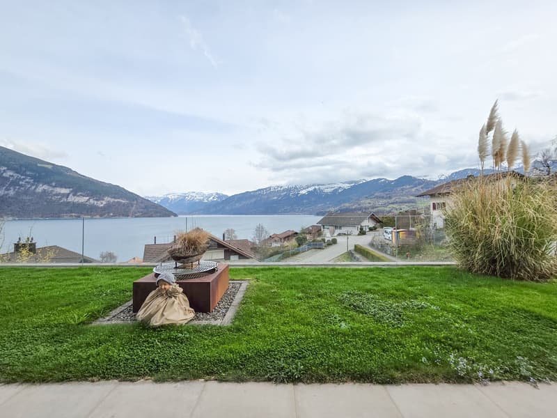 Green lawn, decorative plants, fire pit, lake view, mountains