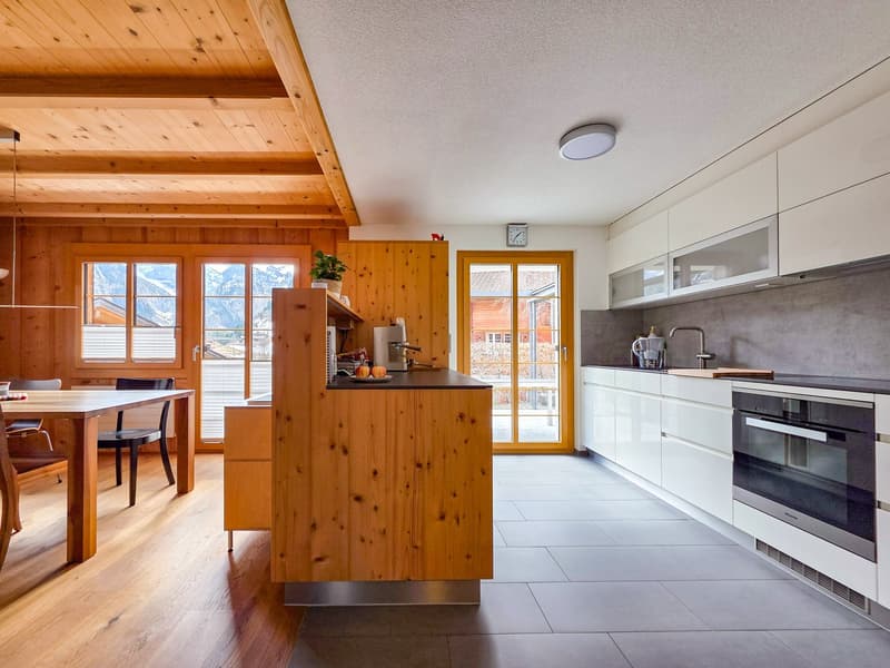kitchen with dining area, wooden ceiling, wooden floor, large windows, modern appliances, dining table, chairs