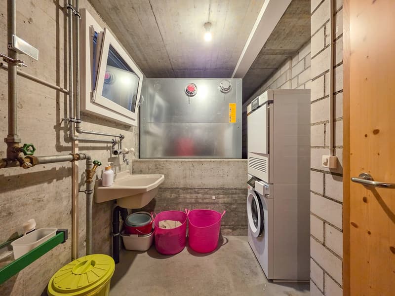 Laundry room with washing machine, dishwasher, sink, and storage buckets