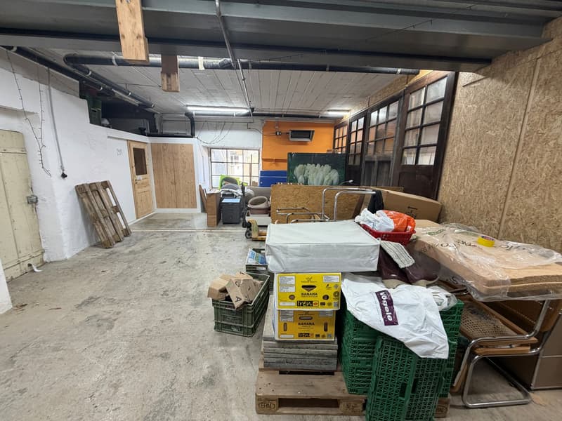 empty warehouse, various boxes and crates, concrete floor, large windows