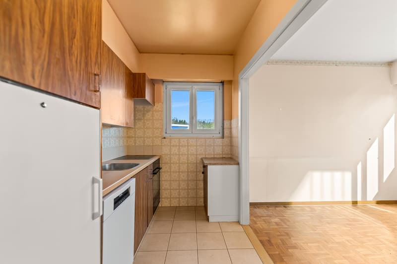 kitchen with wooden cabinets, white appliances, tiled floor, window with view