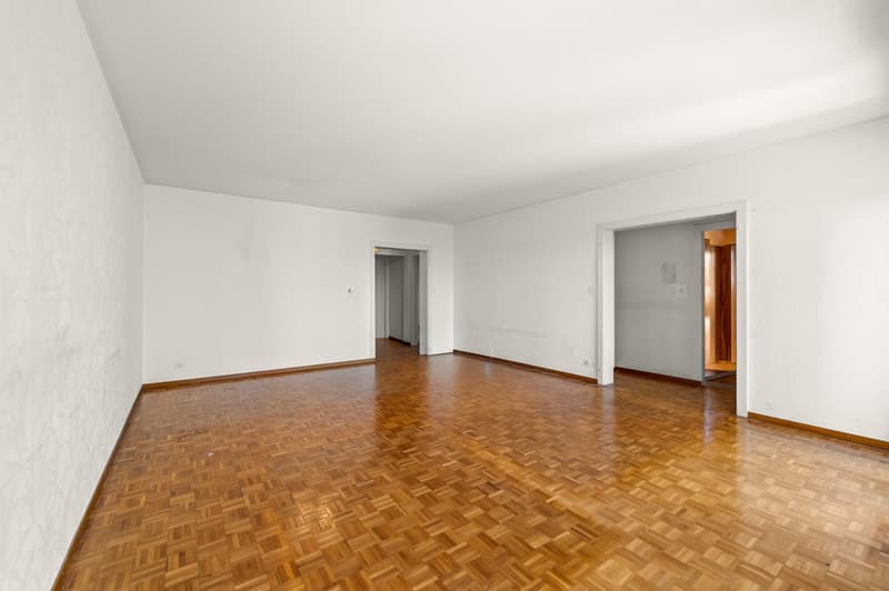 empty room, wooden floor, white walls, two doors