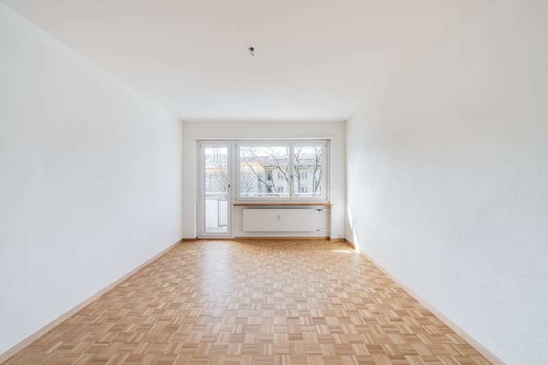 empty room, white walls, wooden parquet floor, large window, sliding glass door