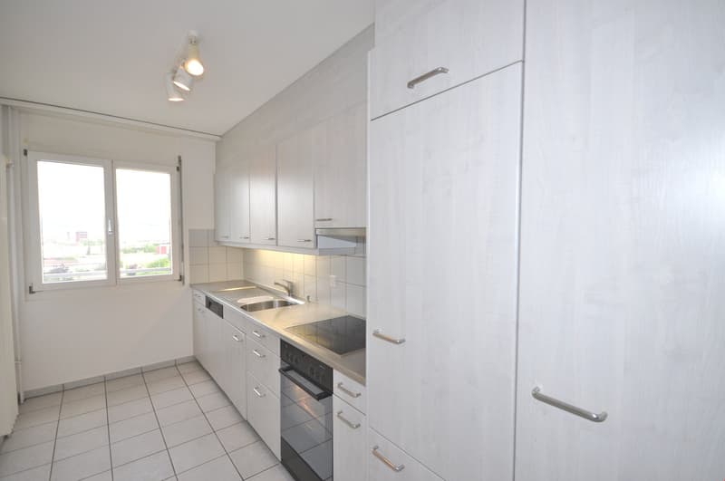 modern kitchen with white cabinets, tiled floor, stainless steel appliances, window