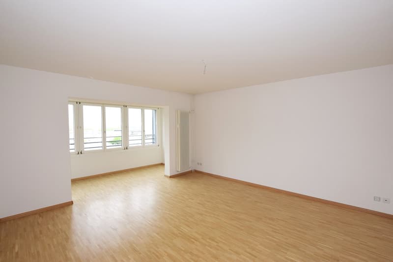 empty room, wooden floor, white walls, large windows, balcony