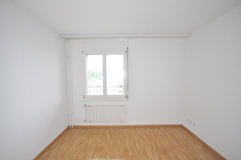 empty room, white walls, wooden floor, white radiator, window