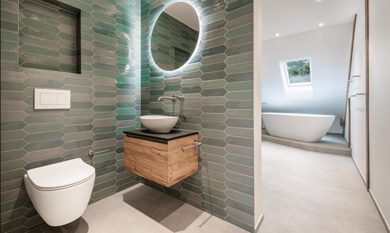 modern bathroom with hexagonal tiles, white toilet, white sink, wooden vanity, round mirror, bathtub, skylight