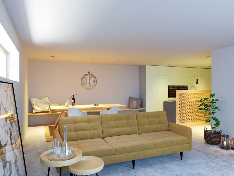 Open-concept living room and kitchen, with a large green sofa, wooden dining table, pendant light fixture, and a kitchen with a patterned backsplash and built-in appliances