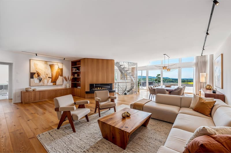 modern living room with fireplace, large windows, wooden floor, wooden coffee table, beige sofa, wooden chairs, wooden cabinet, staircase, dining table, and chairs