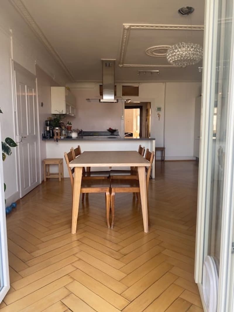 wooden parquet flooring, wooden dining table, wooden chairs, open space to the kitchen, glass door