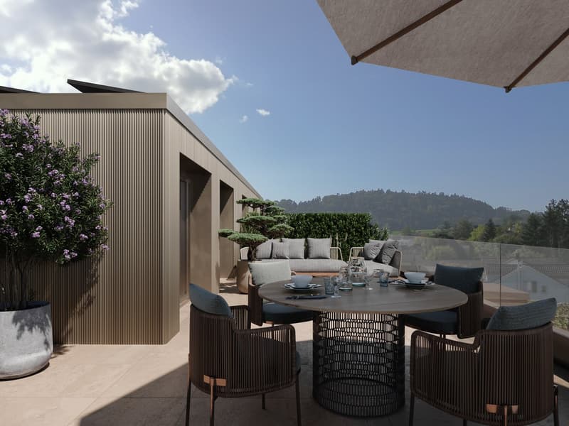 Outdoor dining area with a round table, chairs, and a sofa set, surrounded by plants and a view of the mountains.