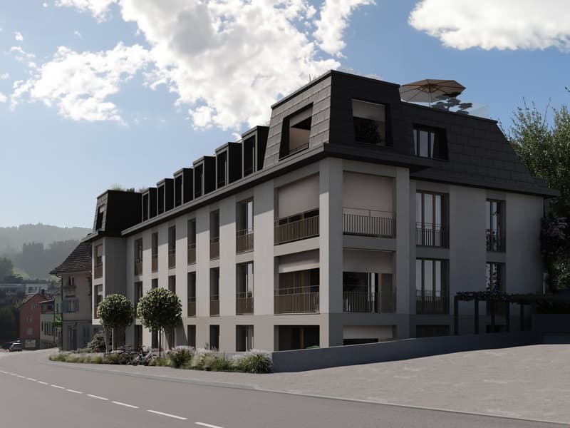Modern apartment building with multiple balconies, black roof, large windows, and a small garden in front