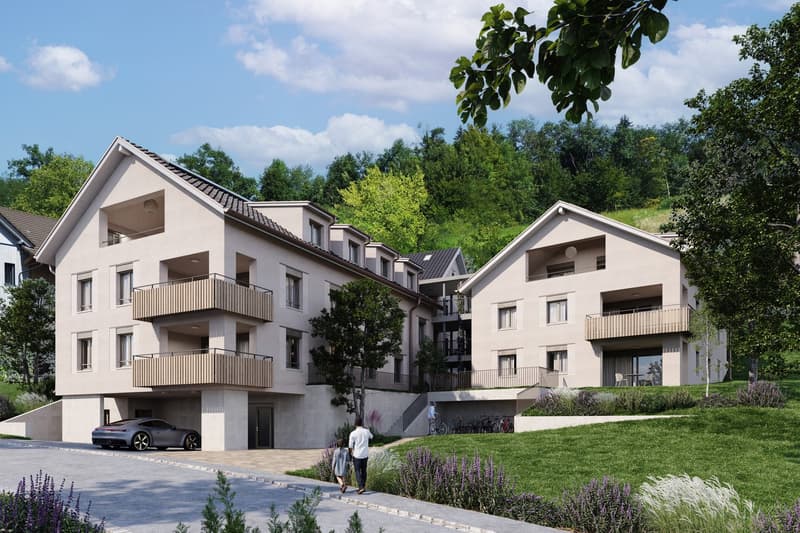 Modern apartment building with balconies, underground parking, and a car parked in front.