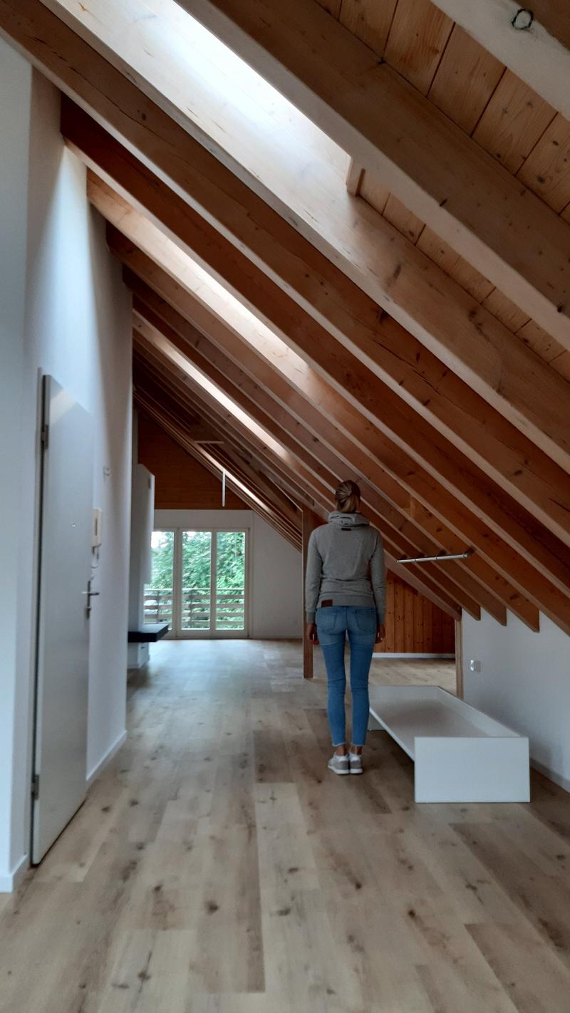 wooden ceiling, wooden floor, white walls, glass door, white bench
