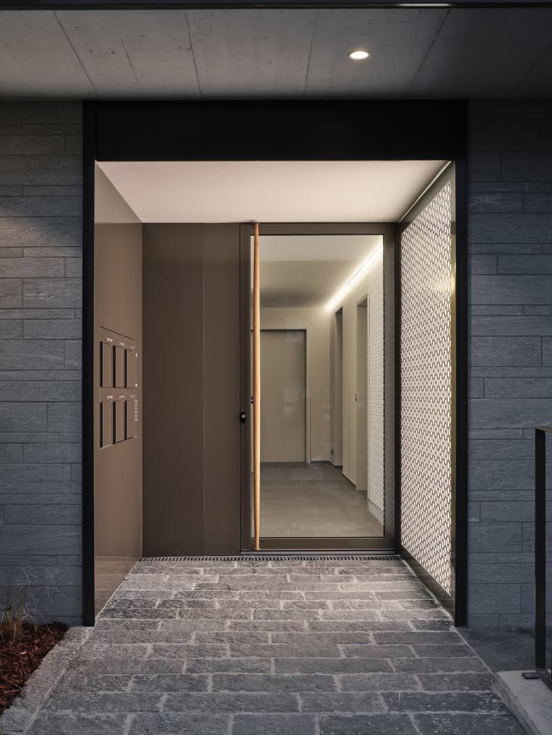 modern exterior, dark gray brick wall, polished grey stone steps, automatic sliding door