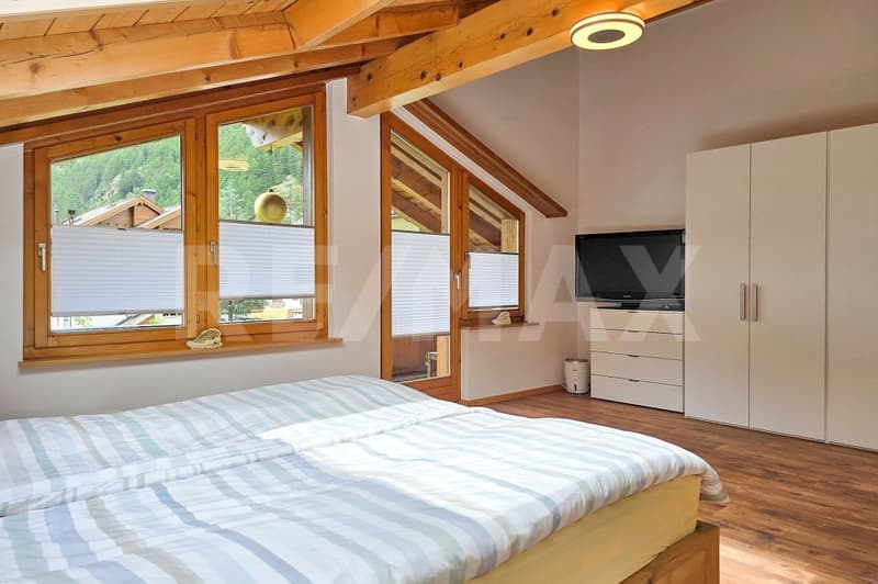 double bed, wooden floor, wooden ceiling, large windows, wardrobe, TV, wooden window frames