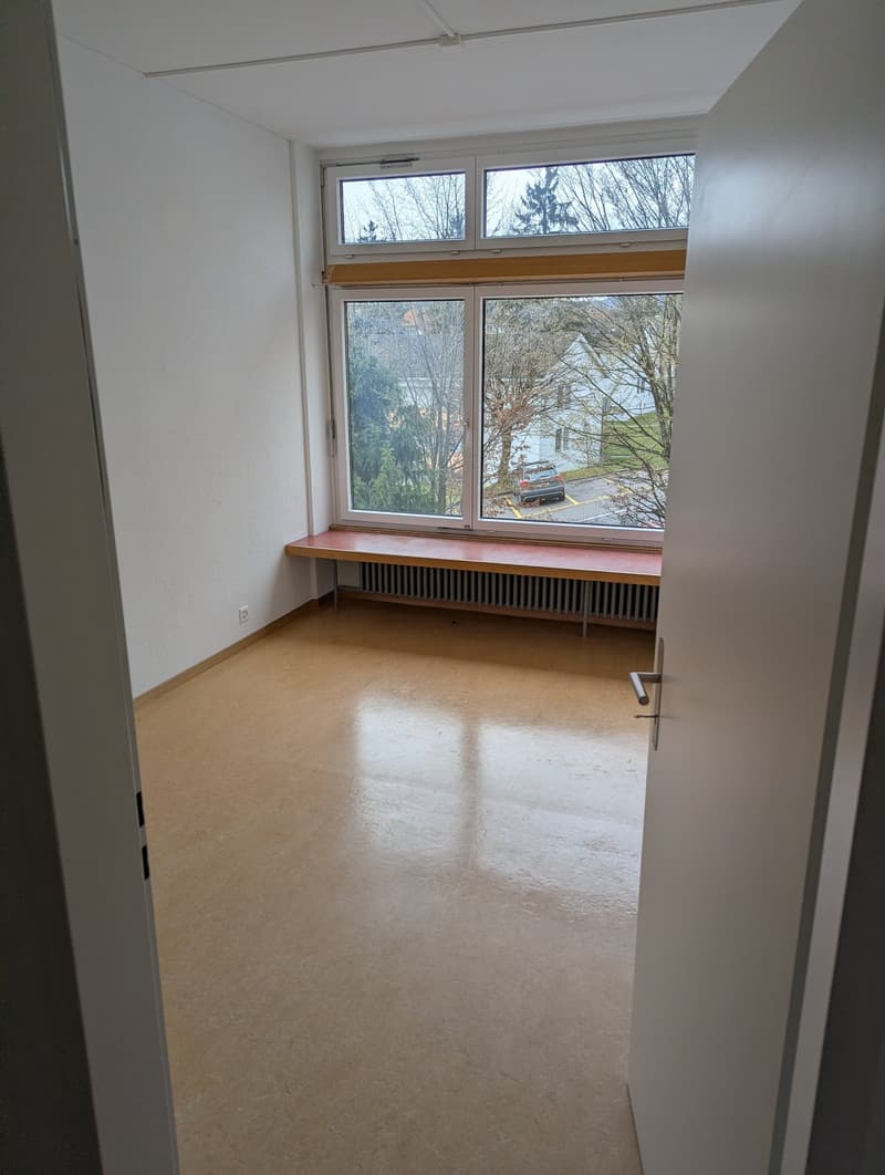 empty room, white walls, wooden floor, large window, bench, radiator
