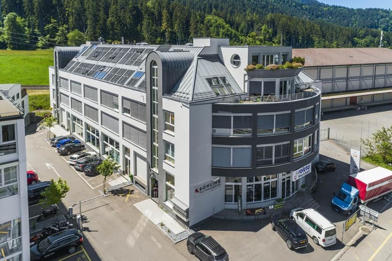 4 story building, parking lot, garage, multiple cars parked