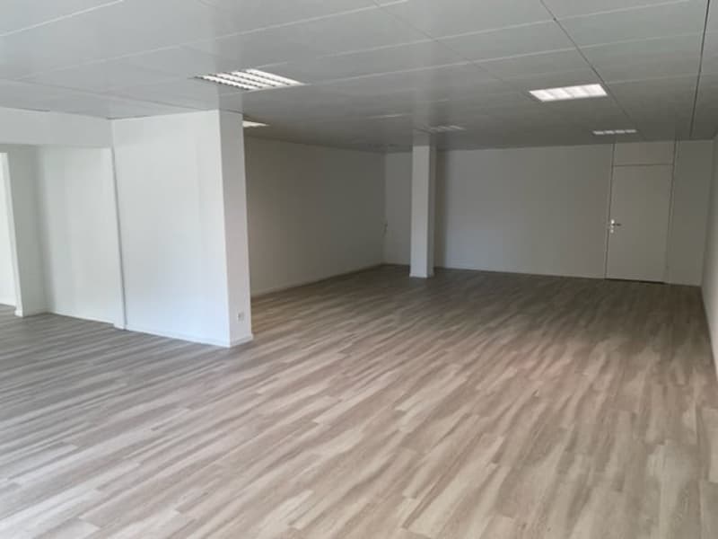 Empty room with wooden flooring, white walls, and white ceiling.