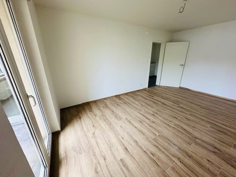 empty room, wooden floor, white walls, sliding glass door, open door