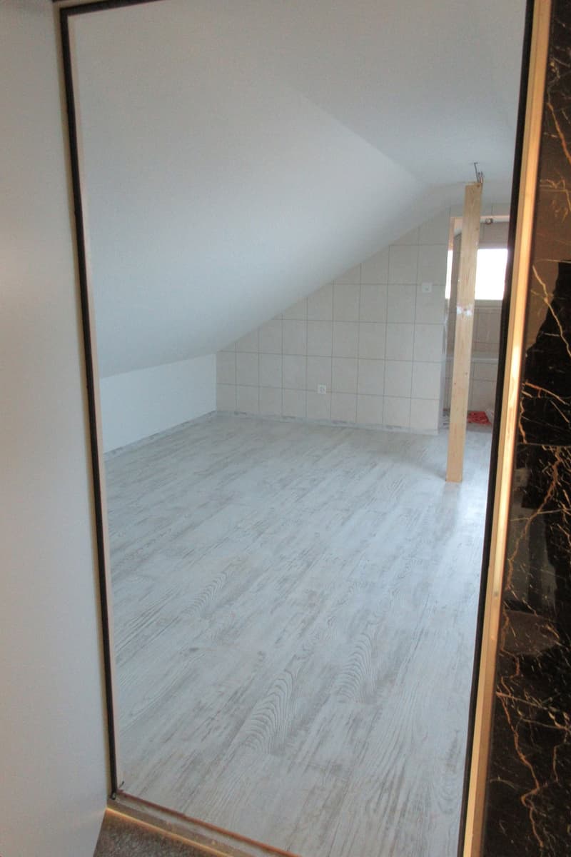 empty room, white walls, white tiles, wooden floor, slanted ceiling