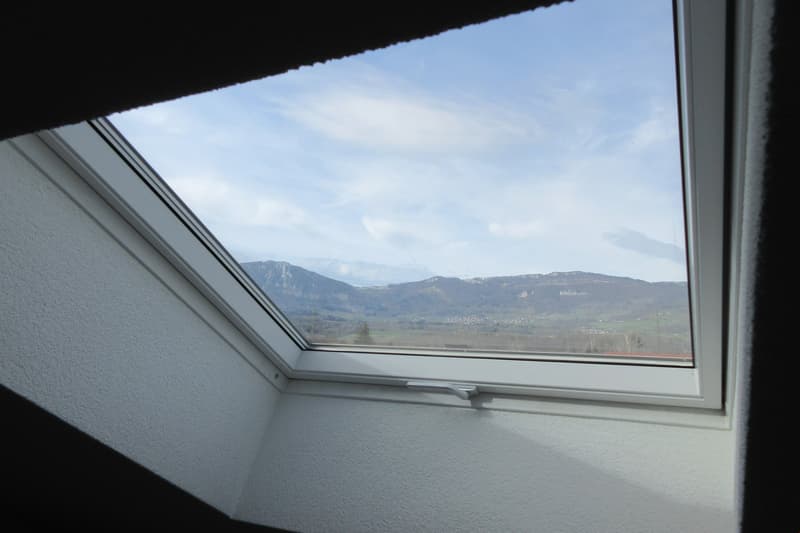 View from a window with mountains in the background