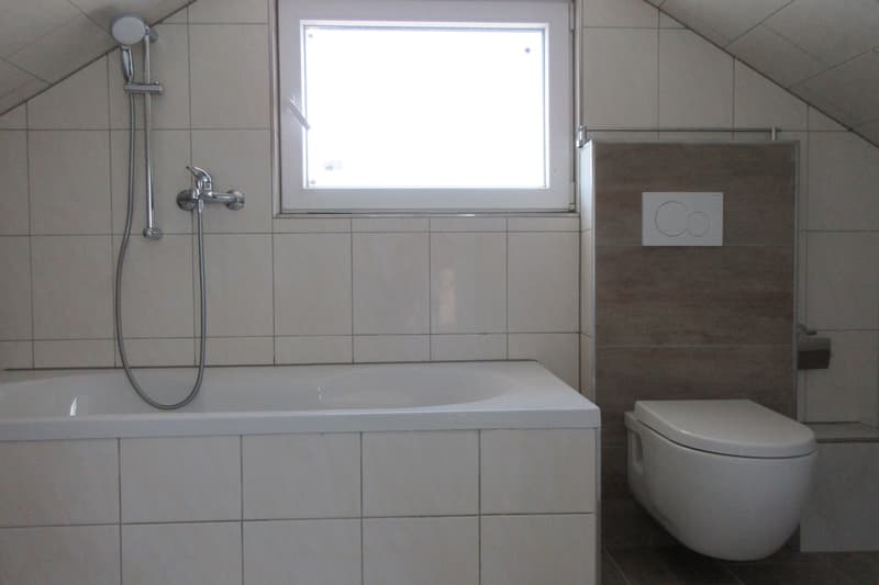 Bathroom with bathtub, shower, toilet, and window