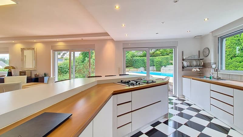 modern kitchen, white cabinets, checkered floor, gas stove, view of swimming pool