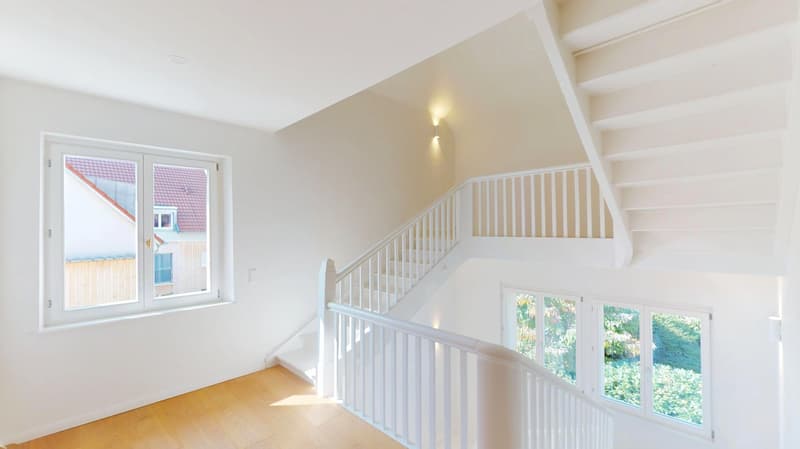 white walls, wooden floor, staircase, windows