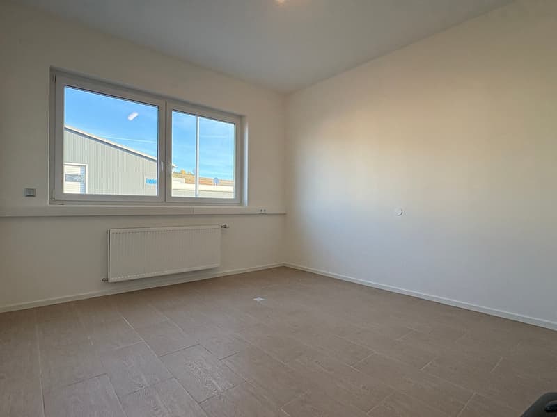 large window, white walls, white radiator, wooden flooring