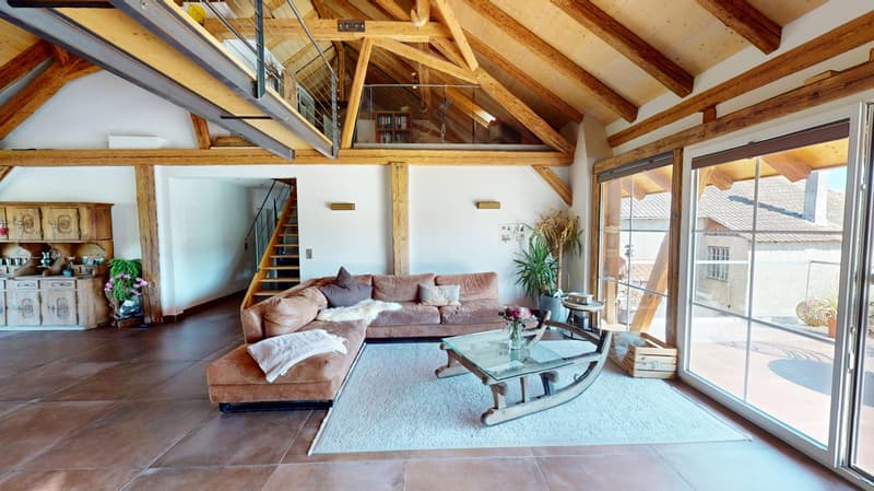 living room, wooden beams, glass wall, couch, coffee table, wooden rocking chair, carpet, stairs, wooden cabinet, plants, outdoor view