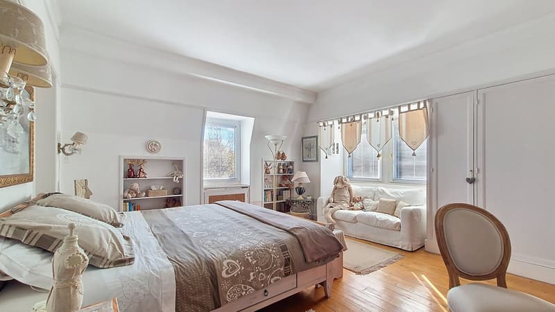 Bedroom with bed, lamp, shelves, chair, couch, carpet, wall decor