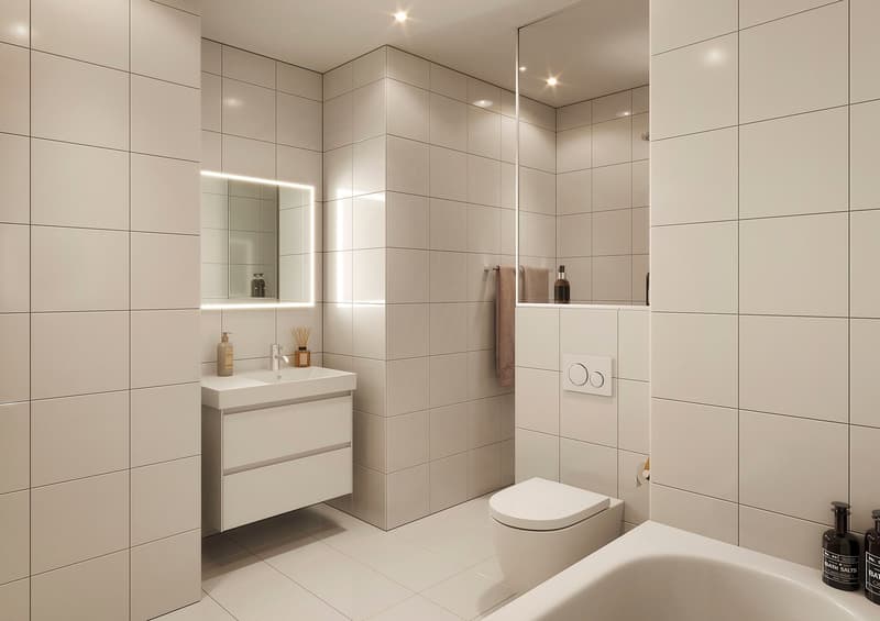 modern bathroom with white tiles, white sink, white toilet, bathtub, mirror, towel rack, toiletries