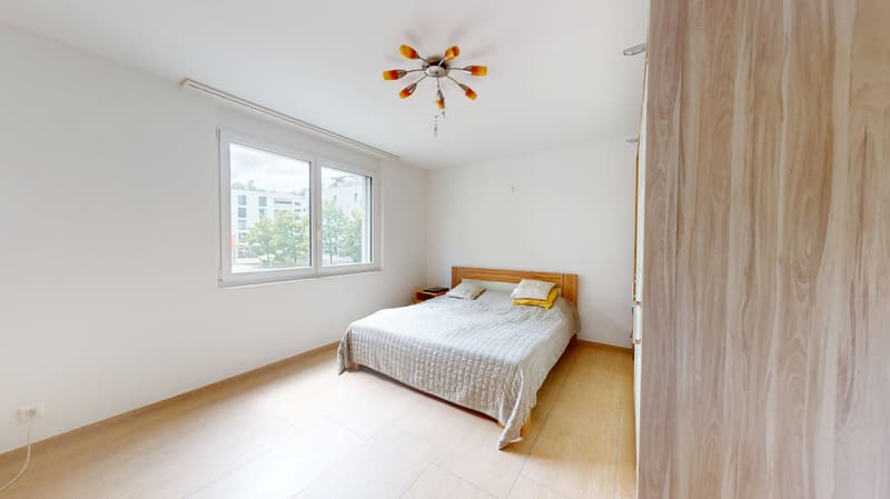 Bedroom with a bed, nightstands, and a window