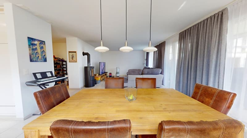 wooden table, leather chairs, fireplace, piano, TV, couch, curtains