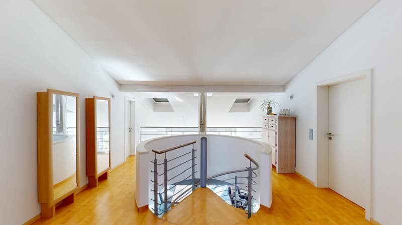 wooden floor, white walls, spiral staircase, wooden cabinet, mirror, glass railing