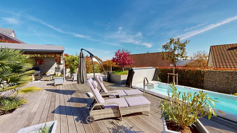 wooden deck, lounge chairs, jacuzzi, plants, trees, bushes, clear blue sky