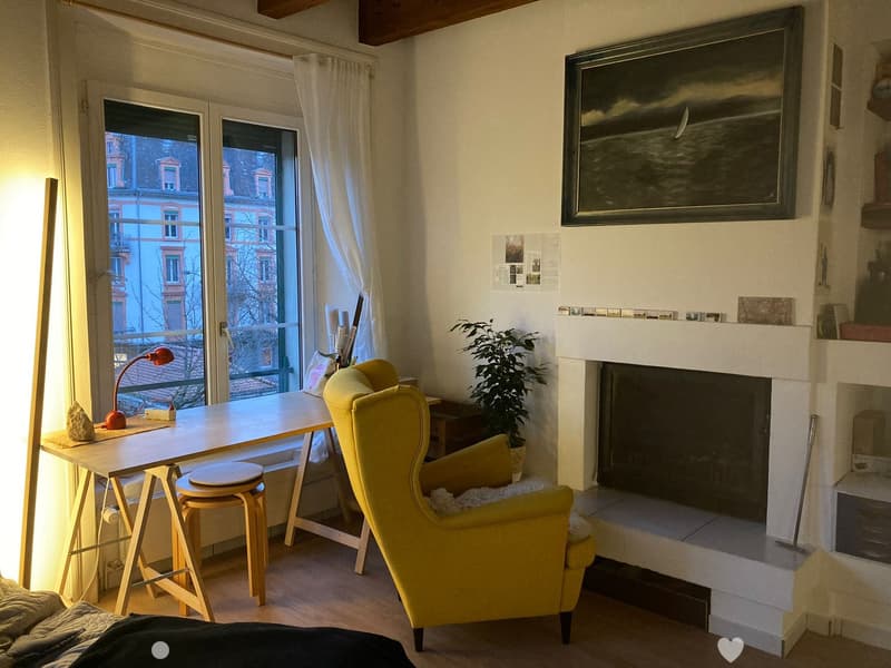 yellow armchair, wooden desk, lamp, fireplace, view to the street