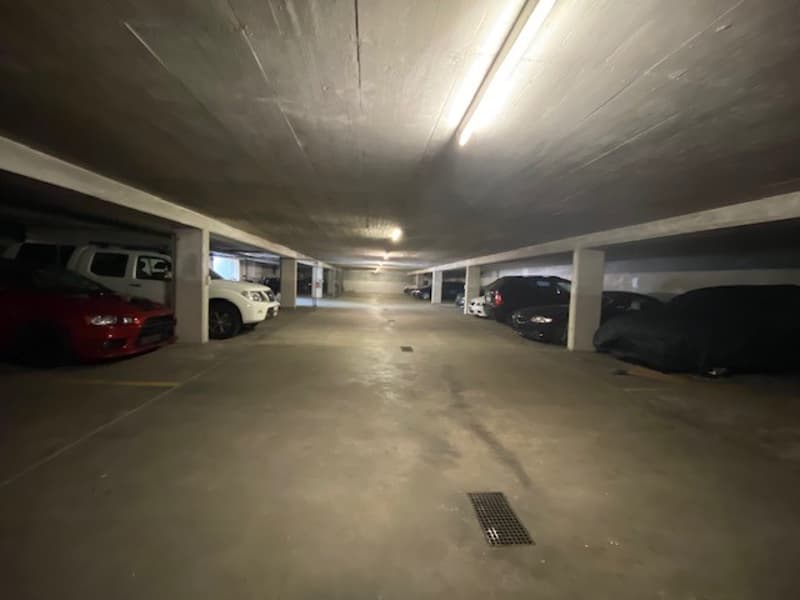 spacious parking lot with several cars parked